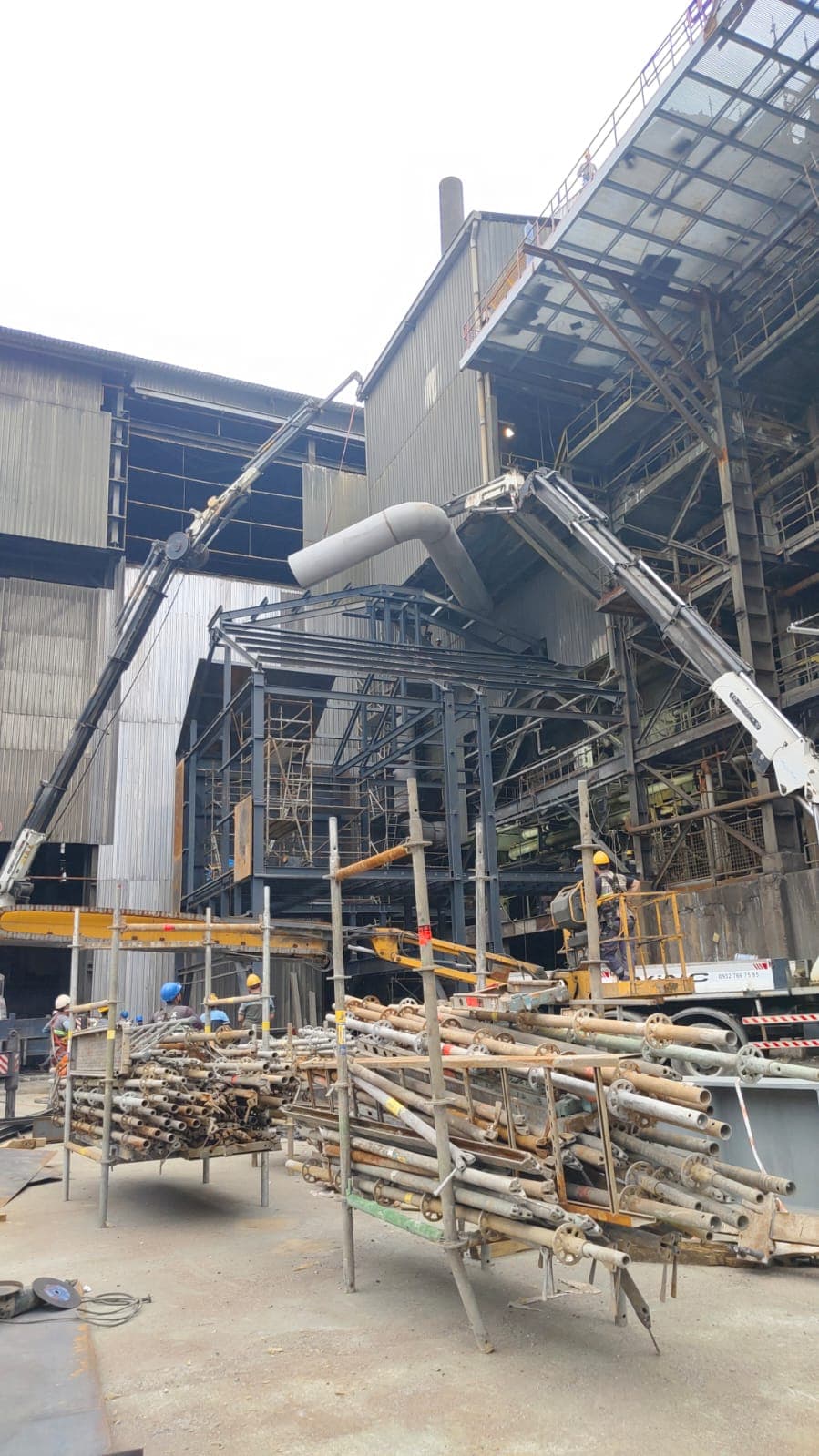 HRSG heat recovery unit lifted by crane during installation at steel plant