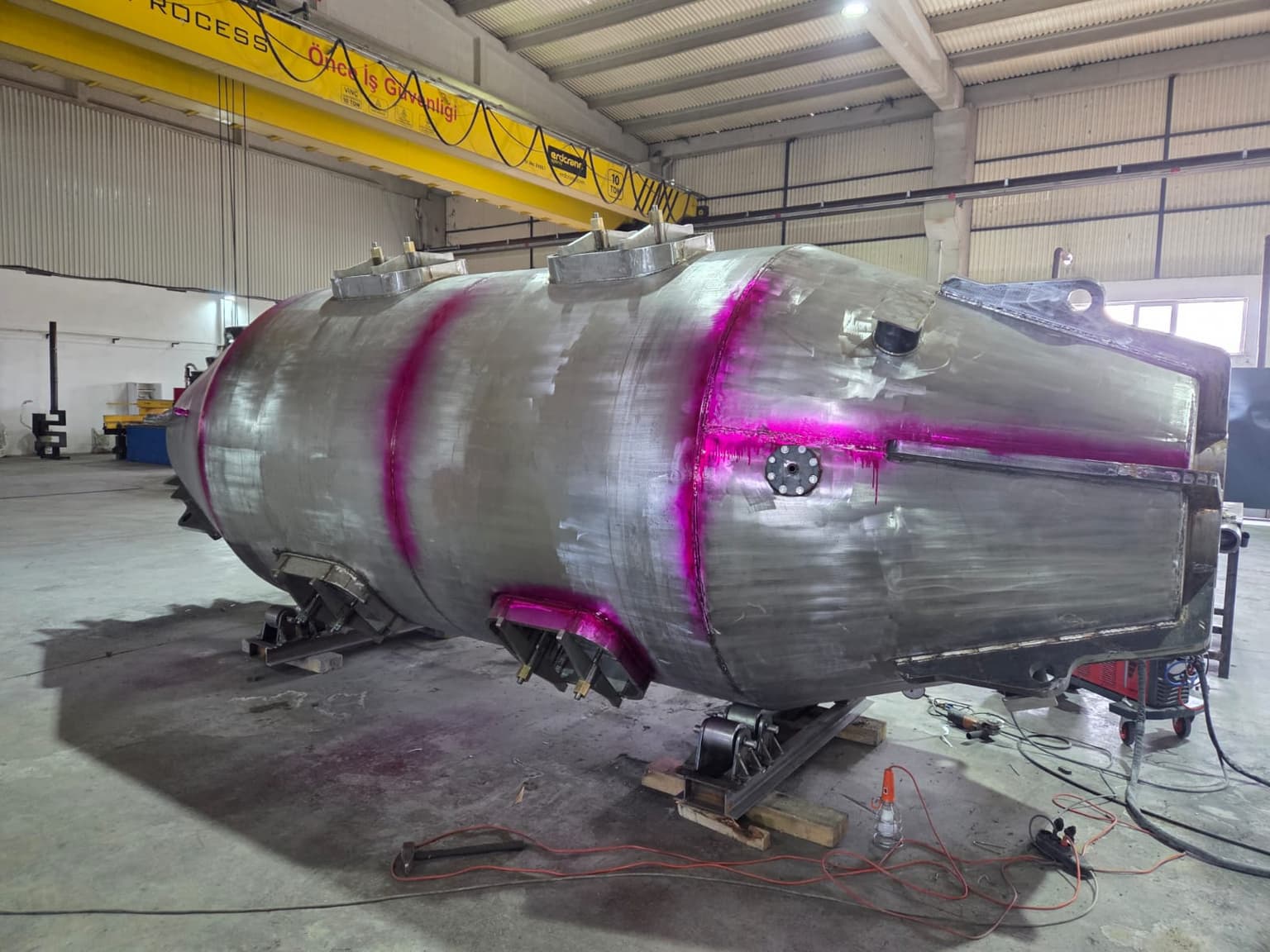 Dye penetrant weld inspection quality control on pressure vessel in workshop